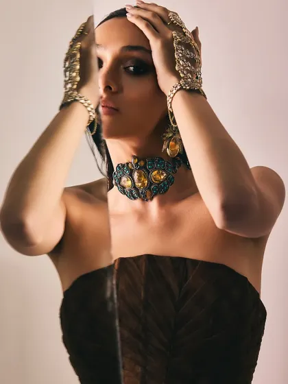 A creative shot for Reasons Jewellery using a mirror to create a reflection, focusing on the intricate design of the choker and hand harnesses.