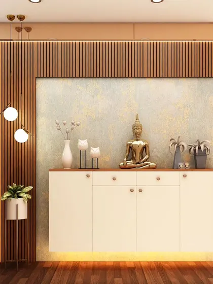 A minimalist pooja unit featuring a simple console with a Buddha statue. The backdrop of fluted wood paneling adds warmth and texture, creating a calm and understated spiritual corner.