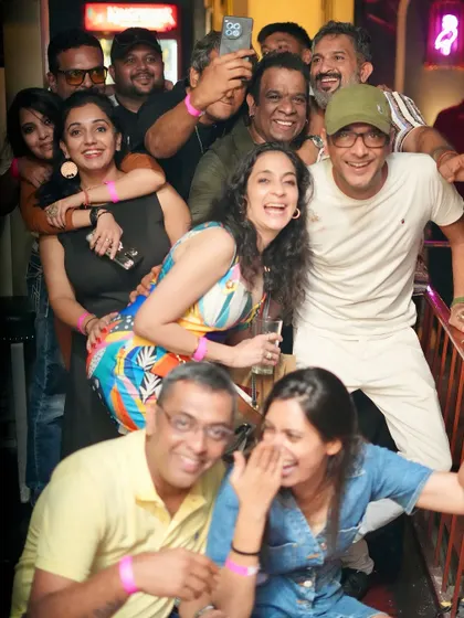 A big group photo with friends and fans celebrating a birthday.