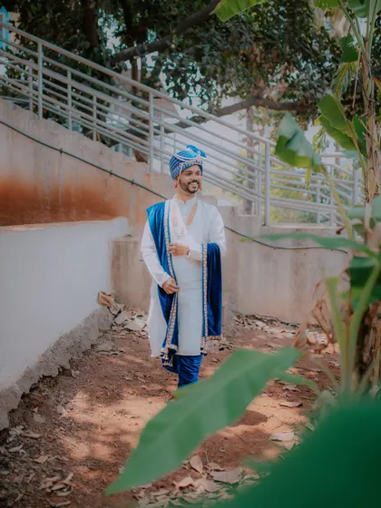 A candid shot of the groom walking at the wedding venue.