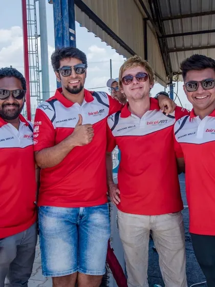 Key members of our team, including drivers and management, at the track. A strong, collaborative team is the backbone of our success.