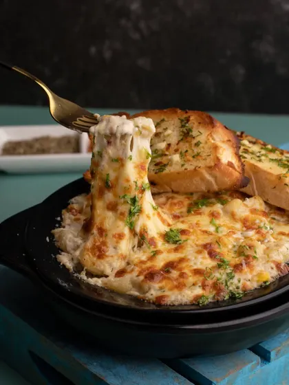 The ultimate comfort food: mac and cheese with an epic cheese pull. This shot is all about showcasing the gooey, cheesy goodness that makes this dish a universal favorite.