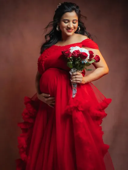 Embrace the power and beauty of motherhood in this stunning red off-shoulder ruffle gown. The vibrant color and soft texture make it a popular choice for clients who want bold, memorable photos.