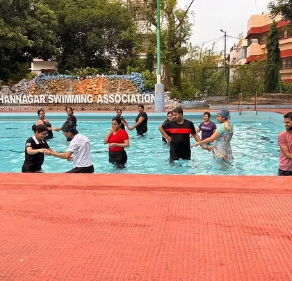 Another view of the partnered exercises in the pool, a great way to build strength and stability with the gentle resistance of water.