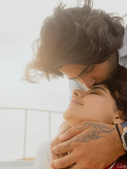 A tender forehead kiss, captured in beautiful natural light. This close-up shot highlights the intimacy and affection between the couple during their destination shoot.