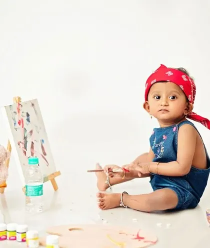 This little one seems to be contemplating her next brushstroke. It's these candid, thoughtful moments that I love to capture.