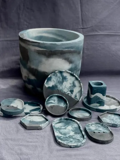 Painting beautiful pictures with concrete. This collection showcases a range of my decor items, including a large planter, trays, coasters, and a soap dish, all in a cohesive blue and grey marbled palette.