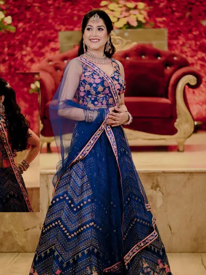A full-length shot of the bride, Pooja, in her stunning royal blue engagement lehenga.