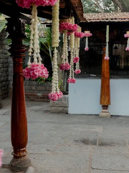Hanging floral decor with pink flowers at a heritage venue.