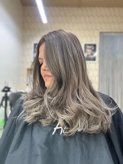 The client enjoying her new ash hair, full of movement and style.