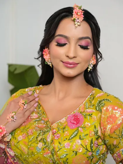 Another close-up of the playful and colorful Haldi look. The makeup is designed to make the bride feel joyful and celebratory.