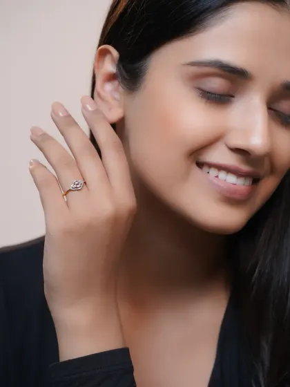 A close-up on the hand, showcasing a different ring from the same brand with a focus on its unique shape.
