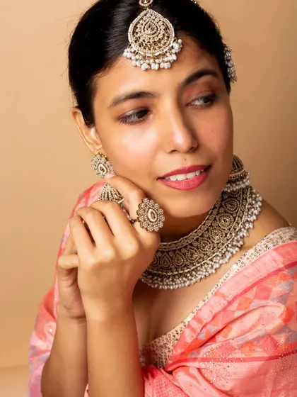 A delicate, expressive pose that highlights the intricate details of the bridal ring, earrings, and necklace, perfect for jewellery catalogue work.