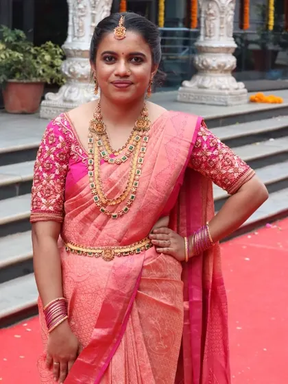 A lovely client ready for her special occasion. Her makeup was designed to complement her bright pink silk saree and layered temple jewelry, creating a balanced and beautiful traditional look.