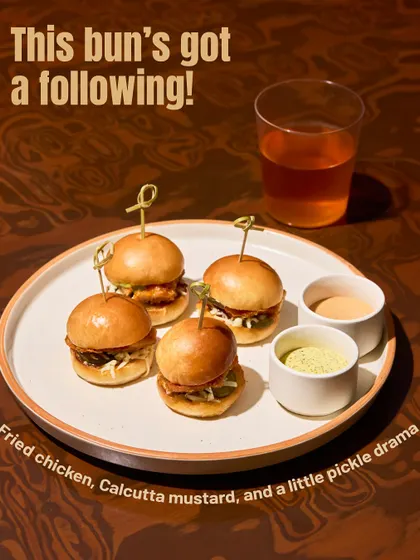This bun has a following. Crispy fried chicken, a kick of Calcutta mustard, and some pickle drama, all in a mini bun. It's a flavour explosion.