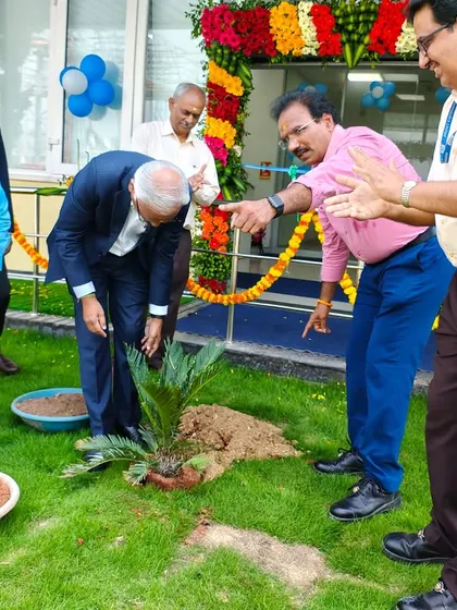 A group of executives and our team members gather around the new plant, demonstrating the shared sense of accomplishment at the project's conclusion.