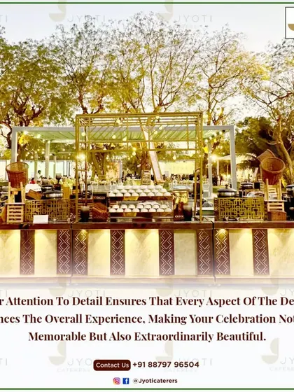 A long shot of a rustic-themed buffet line set against a backdrop of beautiful trees at sunset, creating a warm and inviting glow.