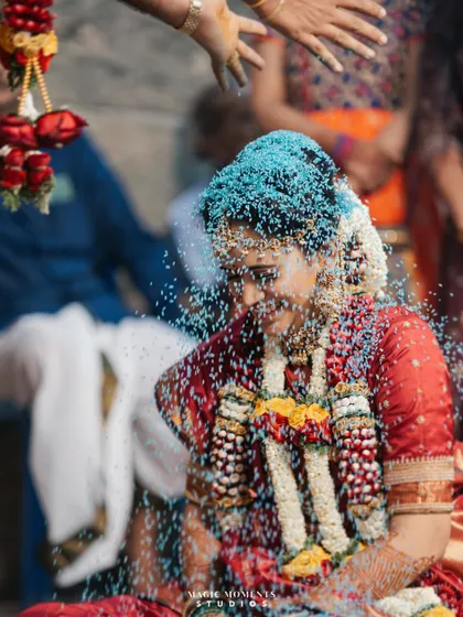 A beautiful shot of the bride, Snigdha, during the Akshata ritual. Her serene expression as she is blessed with rice is a powerful image.