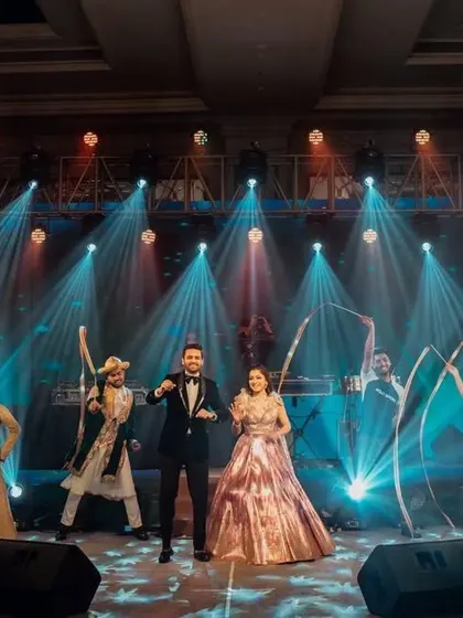 A full Bollywood-themed entry. This couple's entrance featured dancers with ribbons and cold pyro, creating a vibrant and high-energy welcome as they walked in, setting the tone for a fun-filled sangeet.