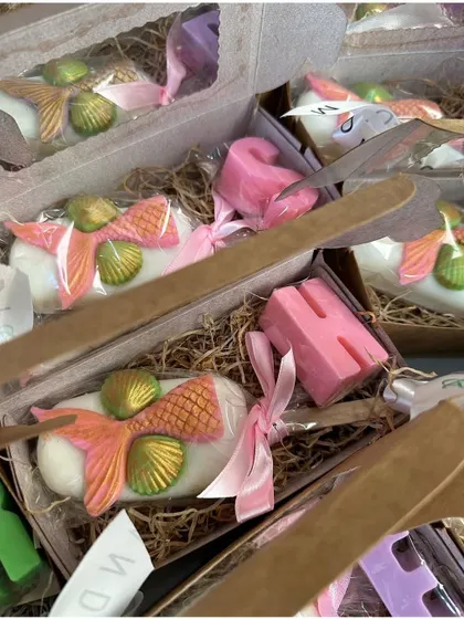A personalized gift box with a pink mermaid tail popsicle soap and a custom alphabet soap, making it a truly special present.