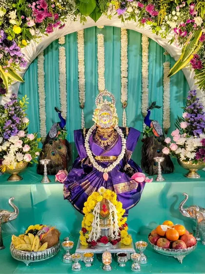The full Varamahalakshmi pooja setup with silver elephant props.