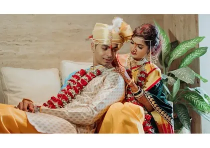 A quiet moment indoors for Rutika and Devendra. The traditional Maharashtrian attire and the loving gesture create a beautiful, classic image.