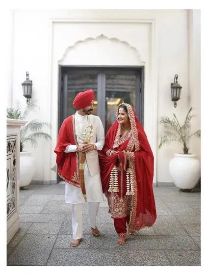 My beautiful Anand Karaj bride Manpreet, walking with her husband. She looks so graceful and elegant in her traditional red suit.