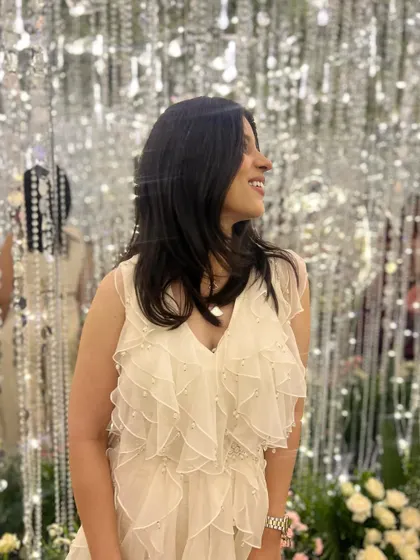 A candid moment from the sangeet. The soft ruffles and pearl embellishments on my jumpsuit caught the light beautifully, making it a truly special occasion outfit.