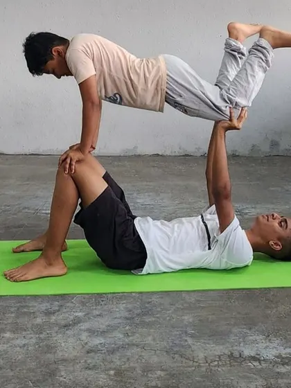 This variation of the "throne" pose in acro-yoga is a fun way to build strength in the base's legs and core control in the flyer.