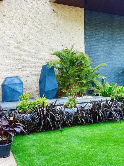 The complete entrance design in Faridabad, with a car approaching, showing how the landscaping creates stunning curb appeal.