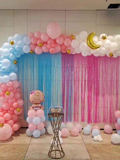 A simple decor for Ria's baby shower party. The pink and blue theme with a fringe curtain backdrop is perfect for a gender reveal celebration.