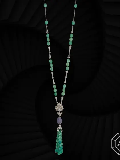 Our exquisite lariat necklace features emerald tumbles, sapphires, rose-cut and round diamond enhancers, and a striking diamond pendant at its center.