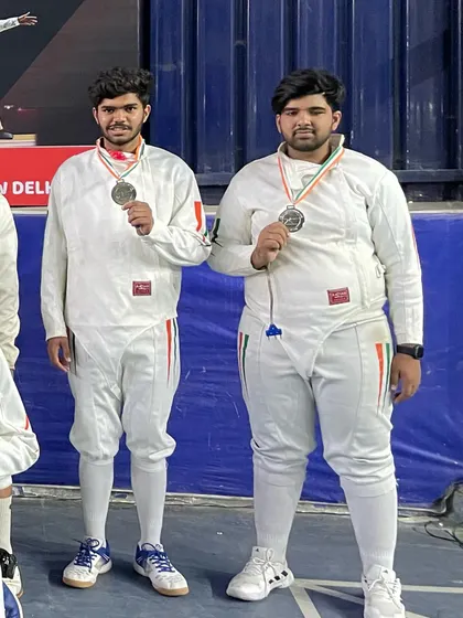 Two of our senior fencers showing off their silver medals after a tough competition at the state level.