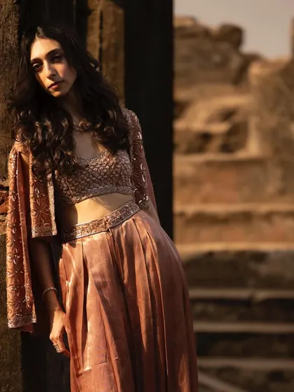 A shot from a photoshoot at some beautiful ruins. The contrast between the delicate outfit and the rustic background is stunning.