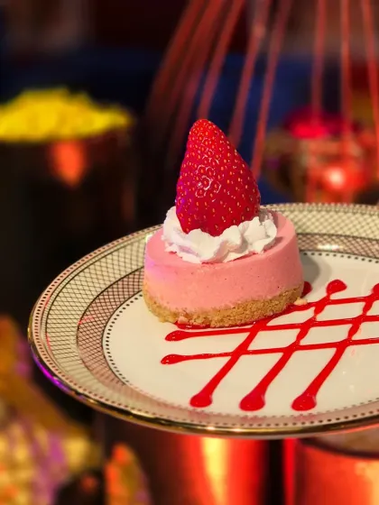 Our Strawberry Cheesecake is a vision in pink. A creamy strawberry-infused filling sits atop a crumbly biscuit base, elegantly plated with a drizzle of berry coulis.