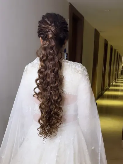 A messy, textured ponytail is a chic and modern choice for a Sangeet or Cocktail party. This style, created for Vaishali, is full of volume and movement, perfect for a night of dancing.