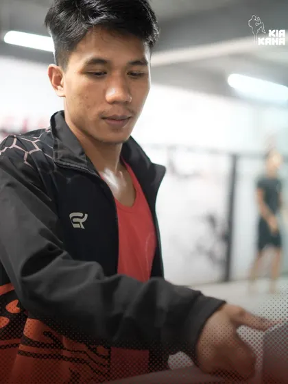 A quiet moment of preparation. A coach gets the gym ready before a class, ensuring everything is in place for our members to have a great session.