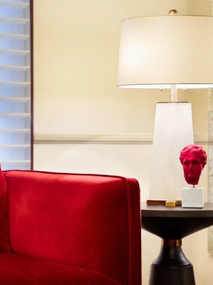 A detail from the Godrej Experience Centre, where a bold red contemporary sculpture and sofa contrast with the classic architecture. This juxtaposition of old and new brings a fresh energy to the space while respecting its heritage.