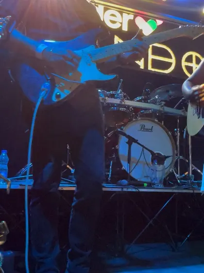 A close-up of my guitarist's hands on the fretboard. It's a glimpse into the technical skill that goes into every show.
