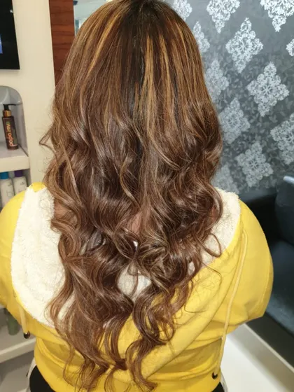 A closer look at the caramel highlights, showing the texture and movement in the hair after styling.