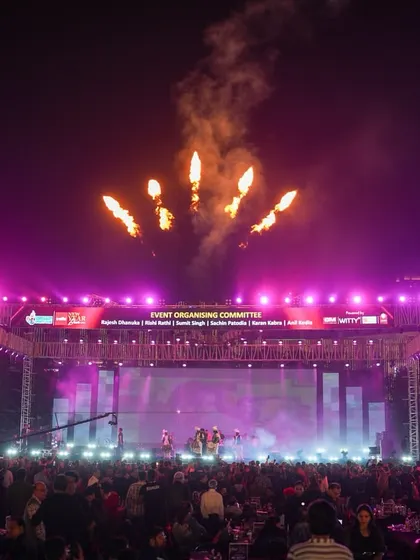 A wide shot of the massive stage setup for the New Year's event, complete with large LED screens, extensive lighting rigs, and aerial fireworks. This demonstrates the scale of our event production capabilities.