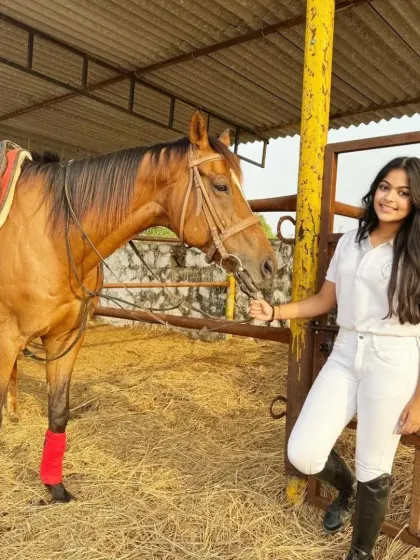A rider stands with her horse in the stables. The time spent before and after the ride is just as important for building a bond.