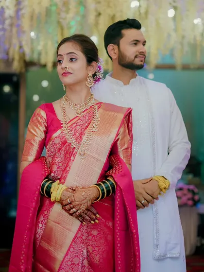 A poised and elegant shot of the couple, looking towards their future together. This photo highlights their beautiful traditional attire and serene connection.