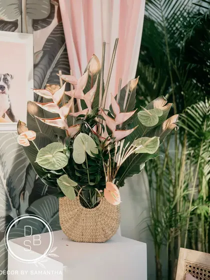 The pink and green color palette celebrated the couple's "opposites attract" love story. Even the table centerpieces, with tropical flowers and playful elements, reflected this theme.