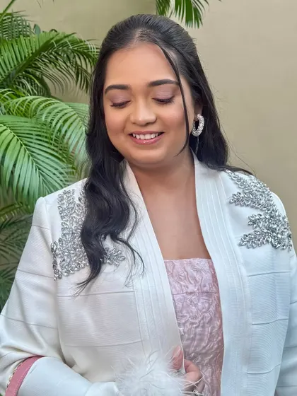 A close-up of the soft pink eyeshadow. The colour is subtle yet adds a beautiful warmth to her overall look.