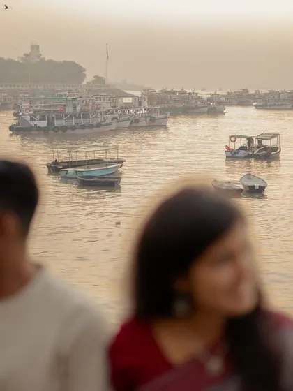 An artistic shot using a shallow depth of field, with the couple out of focus and the serene harbor as the subject. This composition suggests a shared, private world against a beautiful backdrop.