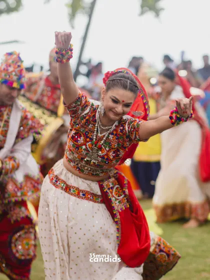 A guest lost in the moment, dancing with joy at a traditional Garba event. We capture the energy of the guests, not just the couple.