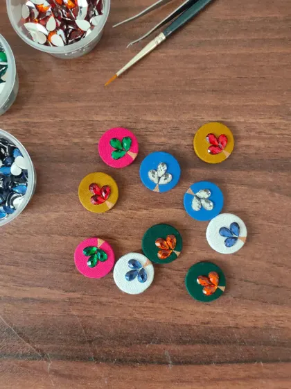 A glimpse of my work-in-progress materials. You can see colorful fabric components, beads, threads, and hand-painted pieces all waiting to be turned into beautiful jewelry.