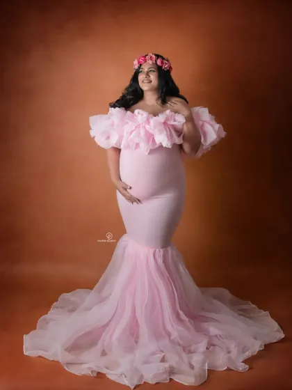 A full-length shot of this beautiful mom-to-be in a pink mermaid gown, complete with a floral crown. This look is perfect for a sweet, feminine, and celebratory maternity session.