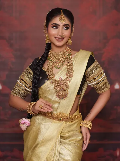 Another full-body shot that showcases the entire ensemble, from the hairstyle down to the elegant fall of the saree.